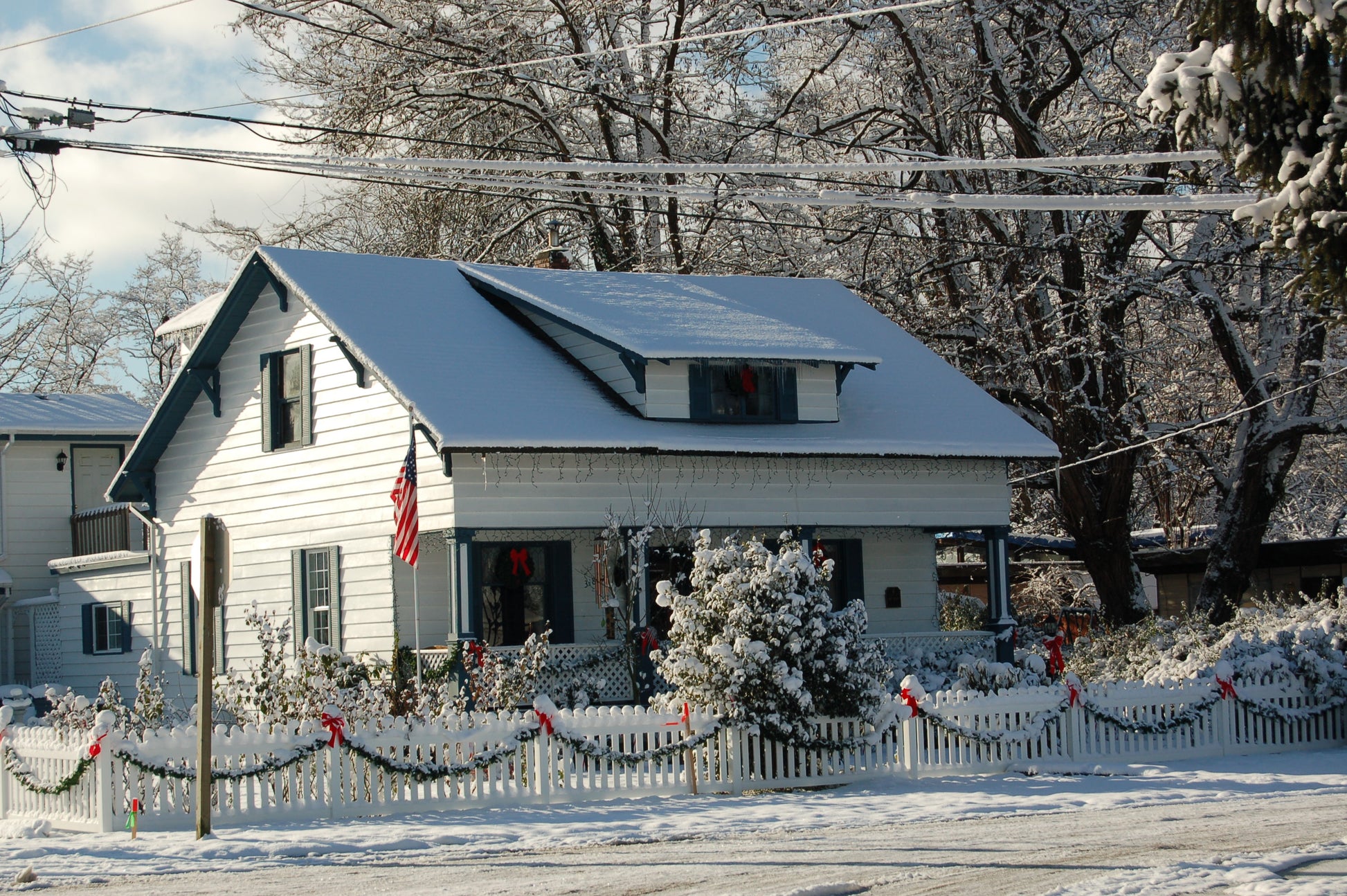 Snow-covered house with Christmas decorations in a winter landscape