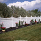 Weatherables Halifax white vinyl privacy fence with decorative plants and flowers in a well-maintained garden.