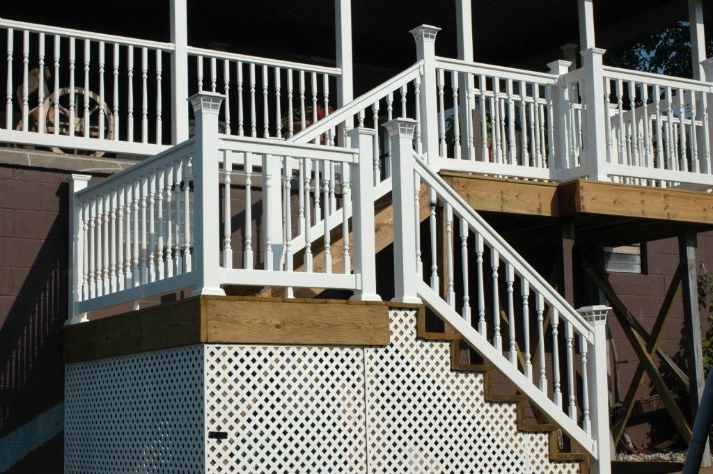 Weatherables Addison white vinyl stair railing and steps on a deck with a dark background