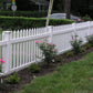 Weatherables Chelsea white vinyl picket fence with flowering bushes and a house in the background