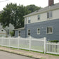Two residential houses with a Weatherables Hampshire white vinyl picket fence in the foreground.