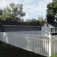 Weatherables Sarasota white vinyl pool fence with a house and trees in the background