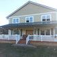 Two-story house with a front porch and Weatherables Burlington white vinyl deck railings