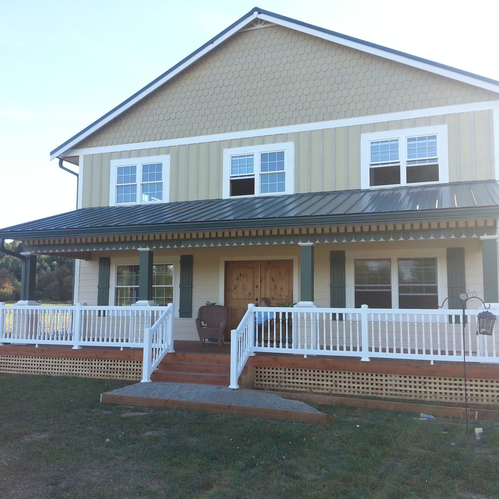 Two-story house with a front porch and Weatherables Burlington white vinyl deck railings