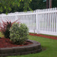 Lawn with garden bed, Weatherables Plymouth white vinyl picket fence, and trees