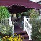 Outdoor deck with purple awning, Weatherables Addison white vinyl deck railing, chairs, and plants