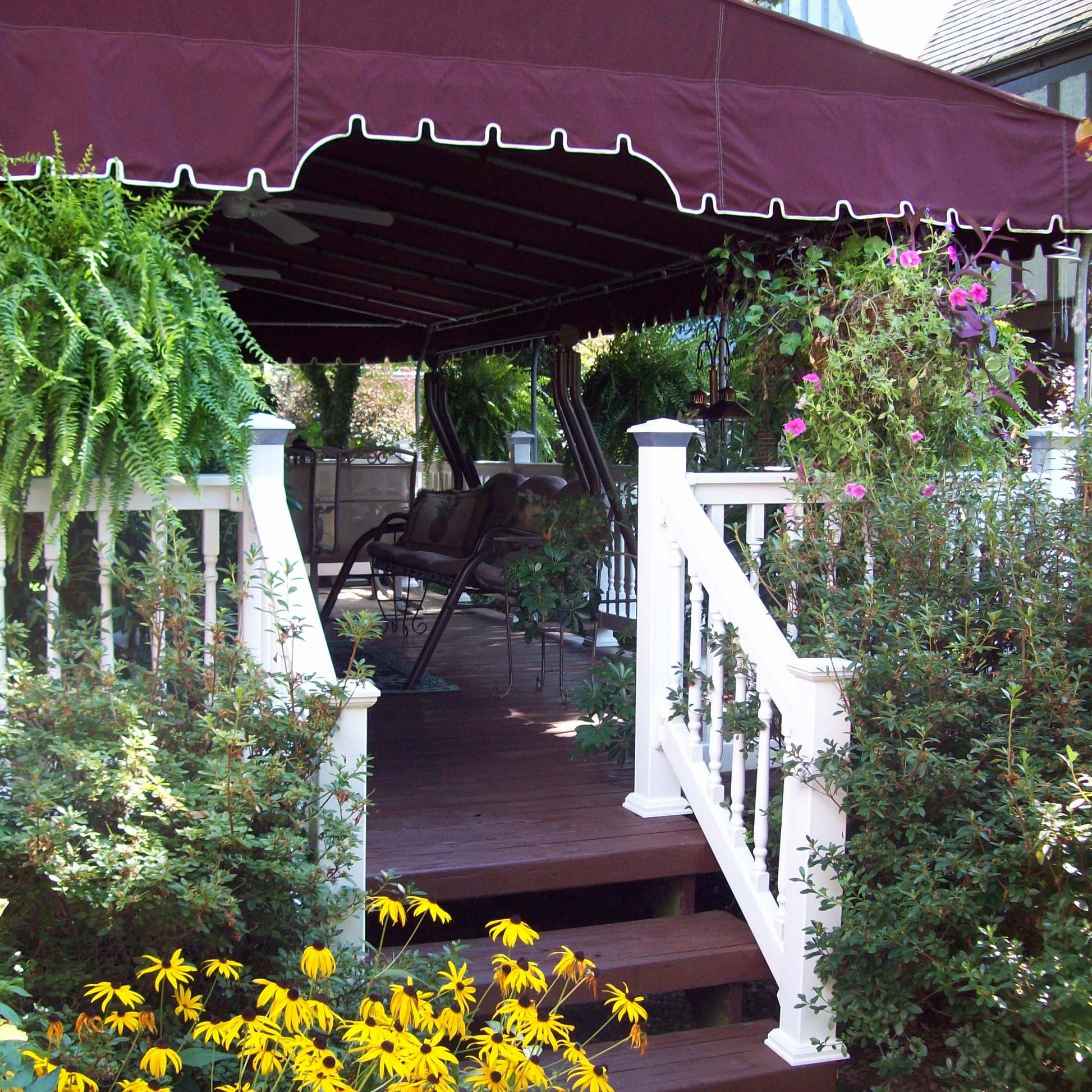 Outdoor deck with purple awning, Weatherables Addison white vinyl deck railing, chairs, and plants