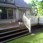 Backyard deck with steps leading to a house, featuring a potted plant, outdoor furniture and Weatherables Berkshire tan vinyl deck railing