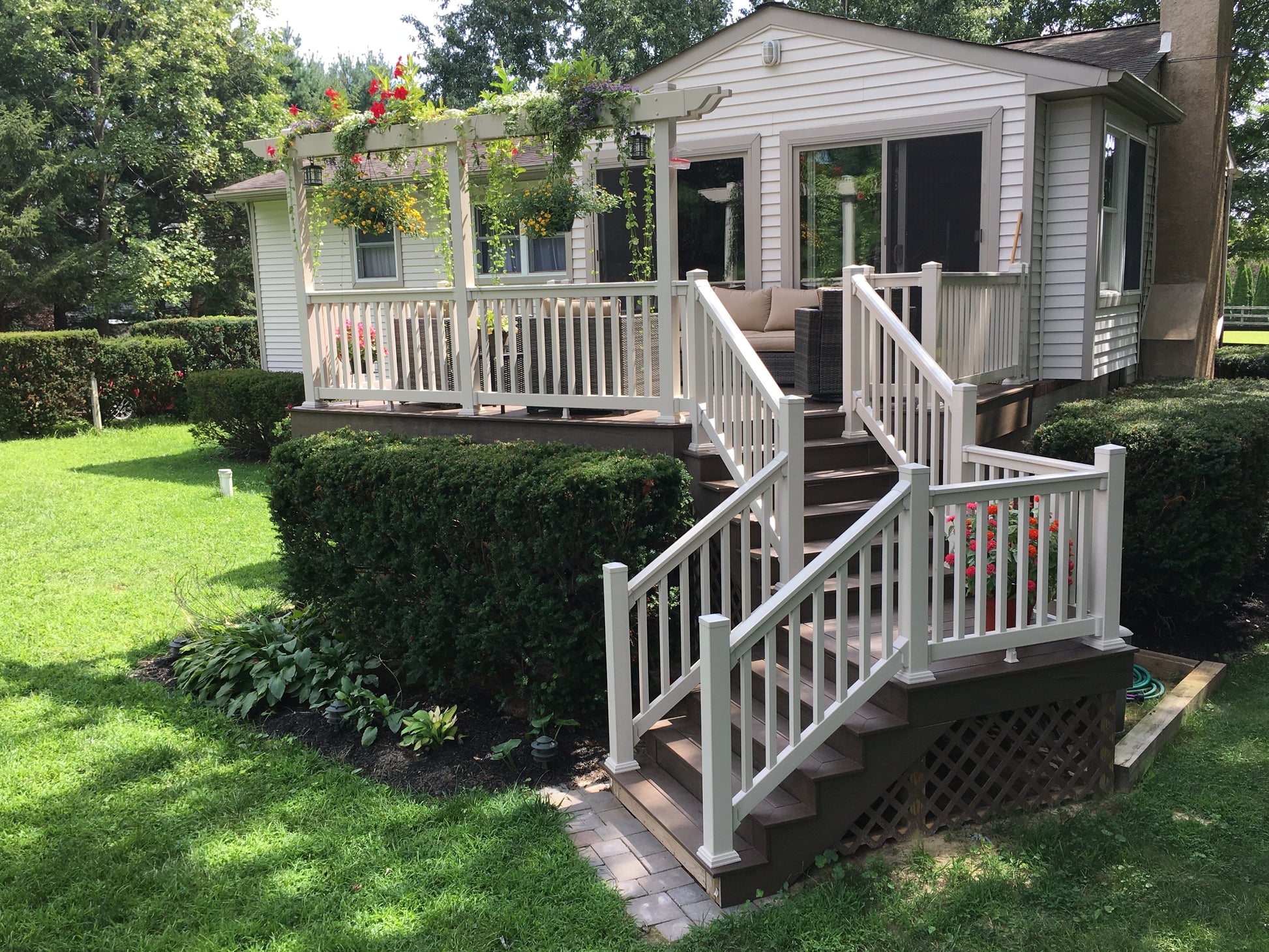 Home with a deck, Weatherables Washington tan vinyl deck railing and outdoor furniture on a sunny day
