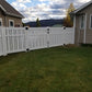 Weatherables Alden white vinyl semi-privacy fence between two houses with a scenic background
