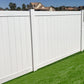 Weatherables Pembroke white vinyl privacy fence with green grass and houses in the background