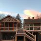 Two houses with Weatherables Wiltshire tan vinyl deck railings and balconies on a clear day.