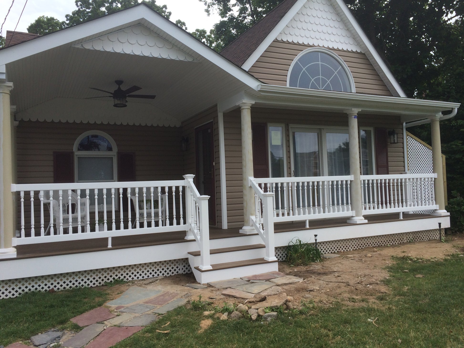 Two-story house with a brown porch, Weatherables Burlington white vinyl deck railing and brown siding