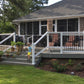 House with a white deck, surrounded by greenery and a small child dreaming of one day owning his own Weatherables Birmingham white vinyl deck and stair railings