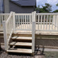 Wooden deck with Weatherables Greenwich white vinyl deck railings and steps leading to a house.