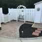 Backyard patio with paved area, garden bed, and Weatherable Alden white vinyl semi-privacy fence.