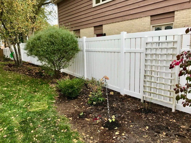 Weatherables Glendale white vinyl semi-privacy fence with lattice design in a residential backyard