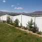 Weatherables Pembroke white vinyl privacy fence with greenery and mountains in the background