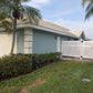 House with a Weatherables Alden white vinyl semi-privacy fence and palm trees in the front