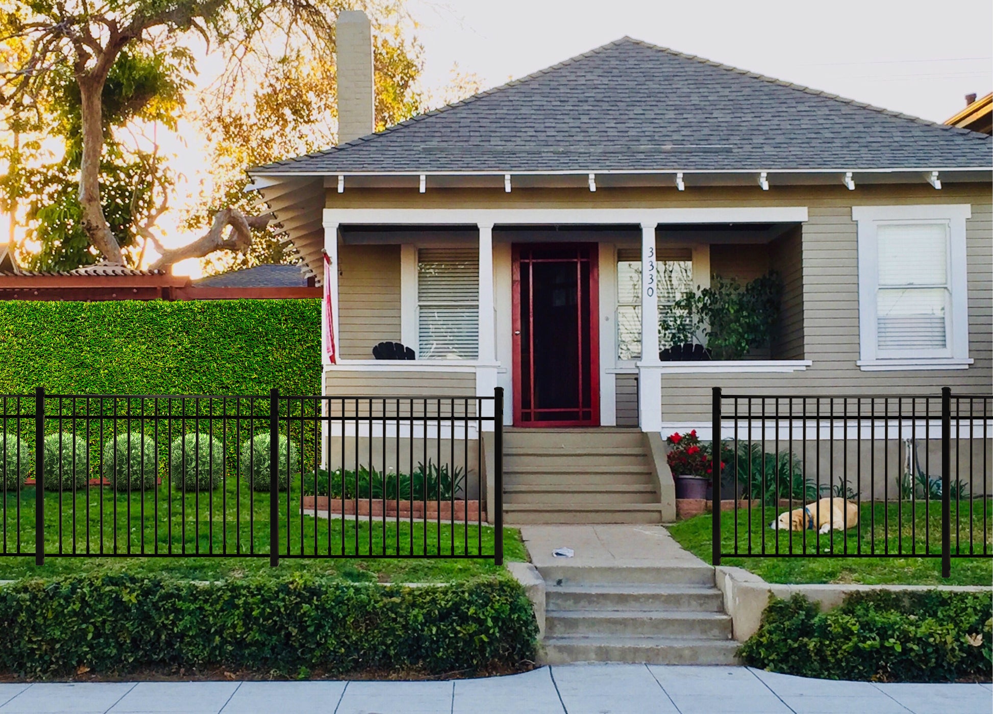 House with a red door and Weatherables Pacific black aluminum fence in a suburban setting