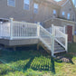 Weatherables Addison white vinyl deck railing on a deck with stairs leading to a house