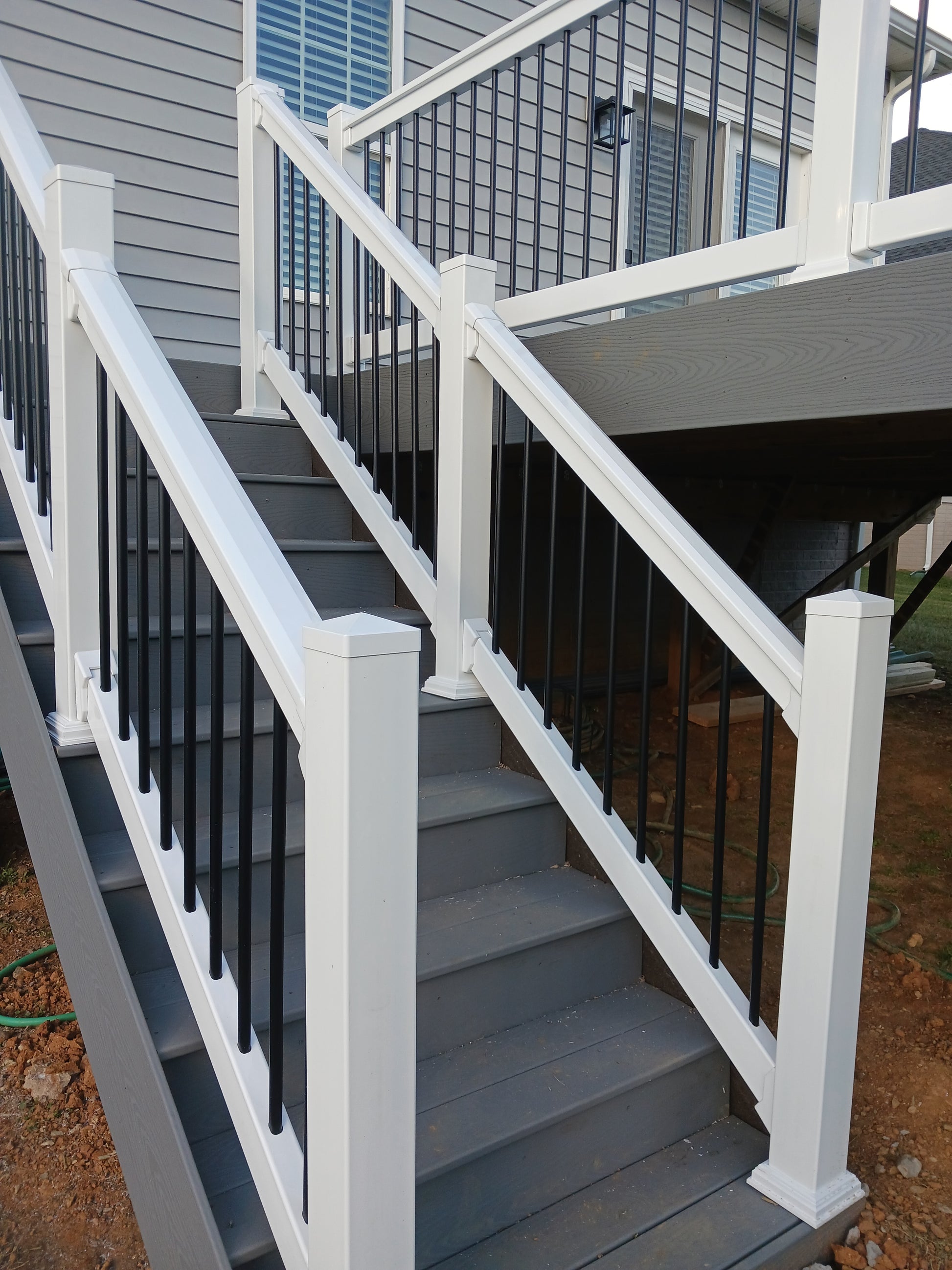 Staircase with Weatherables Bolton white vinyl stair railings on a building exterior