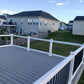 View from a high vantage point of a residential area with Weatherables Bolton white vinyl deck railing, houses and greenery.