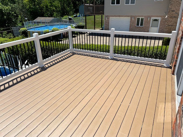 Wooden deck with Weatherables Bolton white vinyl deck railing overlooking a pool and house