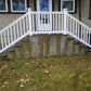 Weatherables Yorkshire white vinyl porch and stair railing on a set off concrete steps leading to a front door.
