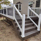 Staircase with Weatherables Bolton white vinyl deck railings leading to a deck on a house.