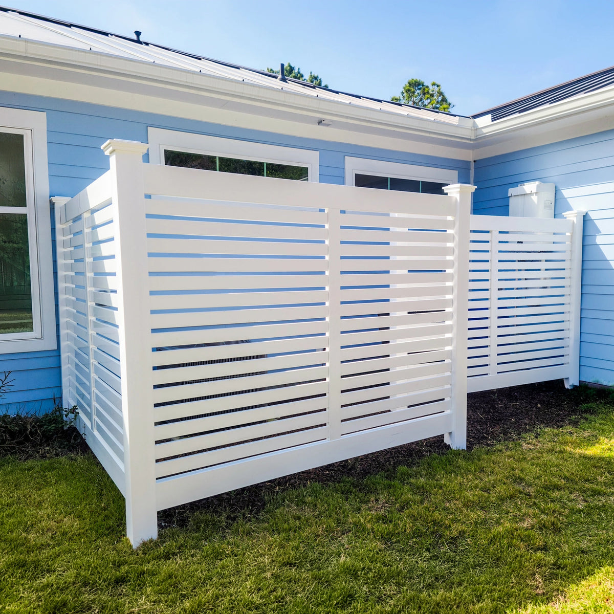 White semi-privacy horizontal fencing used to cover an air conditioning unit beside a house