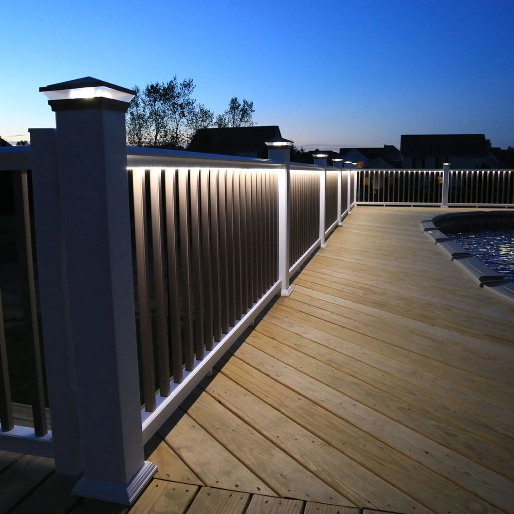 Wooden deck with illuminated railing at dusk