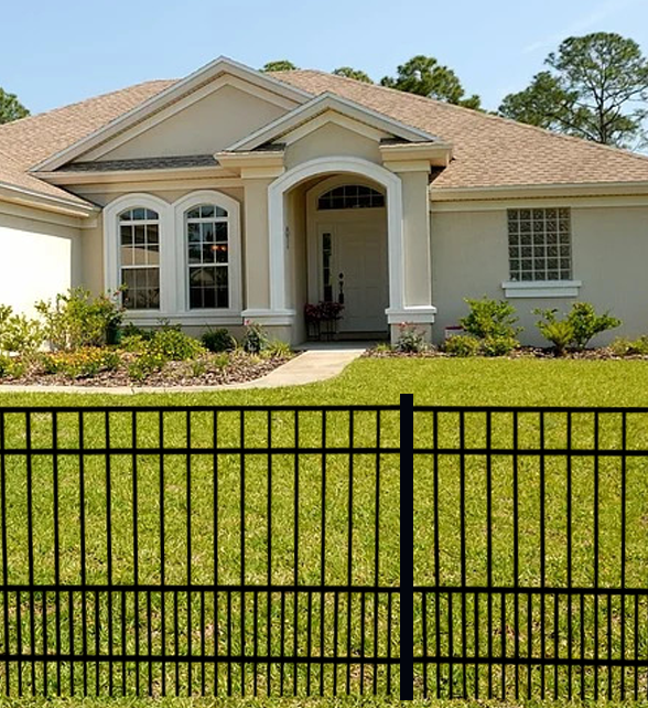House with a Weatherables Terrier puppy picket aluminum fence in the foreground