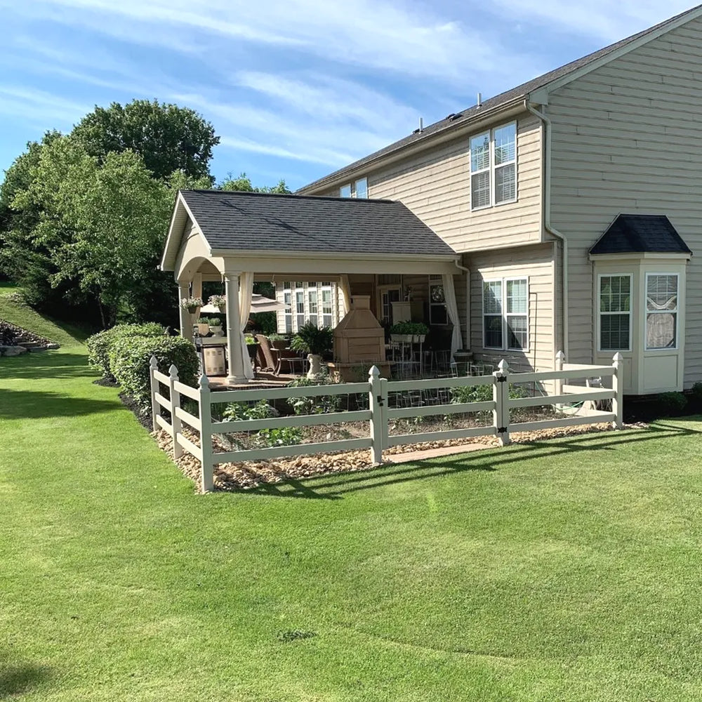 Backyard with a gazebo, outdoor furniture, and a white picket fence.
