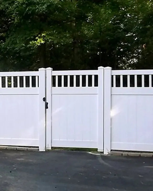 White vinyl fence with a gate in a residential area