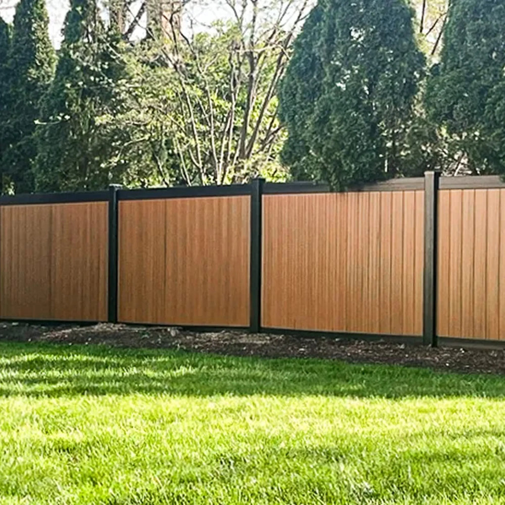 Weatherables Cedar woodgrain privacy fence with black trim in a garden setting